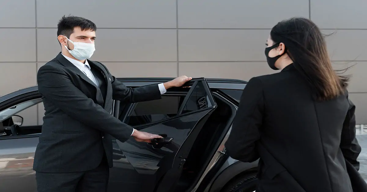 a chauffeur ensuring the safety of the vehicle for his client